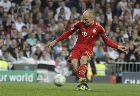 Bayern Munich's Arjen Robben of the Netherlands shoots to score from a penalty during a semifinal, second leg Champions League soccer match against Real Madrid at the Santiago Bernabeu stadium in Madrid Wednesday April 25, 2012.