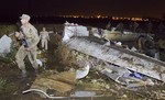 Pakistan army troops sort through the wreckage of the Boeing 737 passenger plane that crashed in the outskirts of Islamabad, Pakistan, Saturday, April 21, 2012.