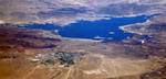 Lake Mead. Boulder City with its two golf courses and airport, is in the foreground. Hoover Dam is on the right.