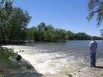 Fisherman beside dam on the Kankakee River at Momence, Illinois, on the north bank, looking southwest