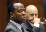 FILE - In this Oct. 3, 2011 file photo, Dr. Conrad Murray listens to testimony seated near his attorney Nareg Gourjian, right, during Murray's trial in the death of pop star Michael Jackson in Los Angeles. Gov. Jerry Brown and others who supported the dramatic shift in California's sentencing law that took effect this week have said it will send only those convicted of nonviolent or non serious crimes to county jails instead of state prison, a change designed to save the state money and reduce i