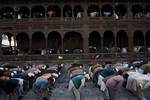 Kashmiri Muslims offer prayers outside a Mosque Mir Sayyid Ali Hamdani, better known as Shah Hamdan in Srinagar, the summer capital of Indian Kashmir, India on 03 November 2011.