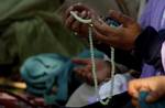 A Kashmiri Muslim woman prays outside a Mosque Mir Sayyid Ali Hamdani, better known as Shah Hamdan in Srinagar, the summer capital of Indian Kashmir, India on 03 November 2011.