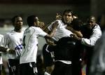 Argentine Carlos Tevez of Brazil's Corinthians, second from right, is hugged by teammates after scoring against Colombia's Deportivo Cali during a Copa Libertadores game in Sao Paulo, Brazil, Wednesday, April 19, 2006.