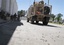 U.S. soldiers, left, stand outside the governor's compound, where used bullets are seen on the ground after an attack of Taliban militants in Kandahar south of Kabul, Afghanistan, Saturday, April 28, 2012.