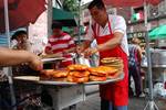 Pambazos being prepared in Mexico City. Pambazo is the name of a Mexican white bread. It is also the name of the dish or antojito (very similar to the torta) made with this bread dipped in a red guajillo pepper sauce and filled with papas con chorizo (potatoes with chorizo)