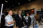 TAMPA, Fla. (June 28, 2006)--LCDR Karrie Trebbe gives a demonstration of the new Homeport portal to Deputy Secretary of Homeland Security Michael Jackson and Coast Guard Commandant Adm. Thad Allen at this year's Coast Guard Innovation Exposition held in Tampa. USCG photo by Telfair H. Brown, Sr. (106093) ( COAST GUARD INNOVATION EXPO (FOR RELEASE0 )