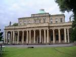 The Pittville Pump Room was the last and largest of the spa buildings to be built in Cheltenham. The well from which the Pump Room's waters originate was first exploited by Henry Skillicorne around 1740, about 25 years after the waters were first discovered in 1716. After the visit to Cheltenham in 1788 of King George III, the town became increasingly fashionable. In the 1820s the local landowner Joseph Pitt determined to develop the northern part of the town as 'Pittville', of which the Pump Ro