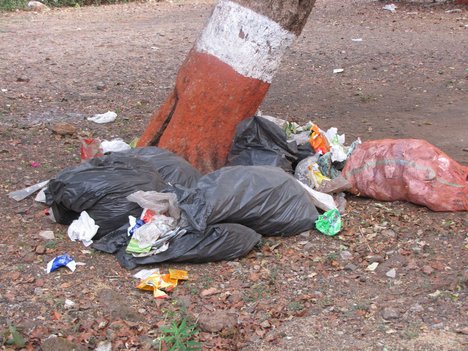 Garbage in the plastic bags on the empty space destroying the environment and it is injurious to health