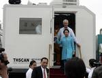 President Gloria Macapagal-Arroyo is accompanied by Finance Secretary Margarito Teves on her way to view the Non-Intrusive Container Inspection (X-ray) Machines Friday (August 10) at the Designated Examination Area of the Port of Manila where two of the