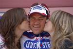 In this Monday, May 10, 2010 file photo, Belgium's Wouter Weylandt receives the kiss of the race hostesses after winning the third stage of the Giro d'Italia, Tour of Italy cycling race, from Amsterdam to Middelburg, the Netherlands. Weylandt has been seriously hurt in a crash during the third stage of the Giro d'Italia, Monday, May 9, 2011. The Leopard-Trek rider fell at high speed during a descent about 20 kilometers (12.4-miles) from the finish and lay motionless on the roadside before parame