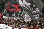 Thousands of Egyptian activists and football fans participate in a march from the headquarters of the Al-Ahly club towards the Egyptian general prosecutor's office in downtown Cairo, Egypt, to protest against what they say the slow pace of procedures taken by the government to find and hold accountable those responsible for football violence in Port Said that claimed scores of victims, Thursday, March 15, 2012. Arabic on the banner reads, "the glory for martyrs." Egypt's top prosecutor on Thursday charged 75 people with murder and negligence in connection with a deadly soccer riot last month in the Mediterranean city of Port Said. At least 74 people were killed in the Feb. 1, 2012 riot, the world's worst soccer-related disaster in 15 years.