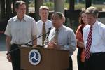 Minnesotans at a US DOT press conference. Left to right: Gov. Tim Pawlenty, Mayor R. T. Rybak, Secretary Mary Peters behind Rep. Keith Ellison (speaking), Rep. Betty McCollum and Sen. Norm Coleman.