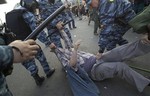 Russian riot police detain a protester as they disperse opposition rally in downtown Moscow on Sunday, May 6, 2012.