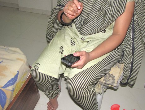 A woman with her mobile phone - cell phone - telecom - India