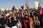 Anti-Mubarak protesters hold up shoes during a protest outside the police academy in Cairo, Egypt, Wednesday, Aug.3, 2011.