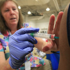 Nurse Susan Peel gives a whooping cough vaccination to a high school student in Sacramento, Calif. The whooping cough vaccine given to babies and toddlers loses much of its effectiveness after by the time people reach their teens and early adulthood.