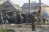 A police officer guards the site of a powerful explosion on the outskirts of Makhachkala, southern Russia, Friday, May 4, 2012.