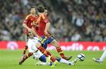 England's Ashley Cole, left, competes for the ball with Spain's David Villa, center back obscured, as Spain's Juan Mata, center front, runs during the international friendly soccer match between England and Spain at Wembley Stadium in London, Saturday, Nov. 12, 2011.