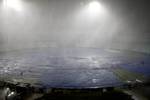 A tarp covers the soaked ground of Eden Garden after a heavy rain before the IPL 5 T20 cricket match between Kolkata Knight Riders and Deccan Chargers on April 24, 2012 in Kolkata in Eastern India City