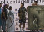 Crickter Sachin Tendulkar receiving a Painting from eminent painter Sanatan Dinda (L) along with West Bengal, Mamata Banerjee, Kolkata Corporation Mayor Sovan Chatterjee and West Bengal Sports Minister Madan Mitra during the congratulates Indian cricketer Sachin Tendulkar(R) for his achievement of a hundred centuries in international cricket ahead of the IPL Twenty20 cricket match between Kolkata Knight Riders and Mumbai Indians at The Eden Gardens in Kolkata on May 12, 2012