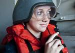 Seaman Katherine Page, from Dayton, Ohio, uses a sound-powered telephone at a replenishment station aboard the Nimitz-class aircraft carrier USS John C. Stennis (CVN 74).