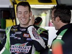 NASCAR driver Kyle Busch talks with crew members in the garage during practice for the NASCAR Sprint Cup Series Auto Race at Dover International Speedway in Dover, De., Friday, Sept. 19, 2008.