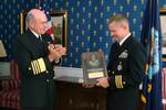 Adm. Vern Clark, Chief of Naval Operations (CNO) applauds Cmdr. Kevin J. Kovacich, former Commanding Officer of Fighter Squadron Two One One (VF-211) after presenting him with the Vice Adm. James Bond Stockdale Award