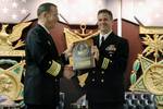 Chief of Naval Operations (CNO) Adm. Mike Mullen congratulates former Commanding Officer, USS Hampton (SSN 767), Cmdr. Robert P. Burke during the Twenty-fifth Annual Vice Admiral James Bond Stockdale Leadership Award Ceremony.