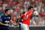 Benfica's Oscar Cardozo, from Paraguay, right, controls the ball ahead of Manchester United's Jonny Evans, from Northern Ireland, during their Champions League group C soccer match Wednesday, Sept. 14 2011, at Benfica's Luz stadium in Lisbon.