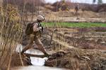 U.S. Marine Lance Cpl. Matthew Bayles, a point man with Alpha Company, 1st Light Armored Reconnaissance Battalion, and native of Plainfield, Ill., crosses over a canal during a patrol here, Feb. 16. Marines and sailors with 1st LAR and India Company, 3rd Battalion, 3rd Marine Regiment, conducted clearing and disrupting operations in and around the villages of Sre Kala and Paygel during Operation Highland Thunder. Marines with 1st LAR led the operation on foot, sweeping for enemy weapons and drug