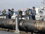 Aviation Boatswain's Mate (Equipment) 3rd Class Matthew Ubinger and Airman Eric McFarland lift a flight deck catapult from its housing aboard the Nimitz-class aircraft carrier USS George Washington (CVN 73).