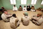 An interpreter explains the concerns of local elders to U.S. Marine Col. Roger Turner (left) and Lt. Col. Matthew Palma (right), the commanding officers of Regimental Combat Team 5 and 3rd Battalion, 3rd Marine Regiment, in a shura held at a school here during Operation Tageer Shamal (Shifting Winds) Jan. 5. Over the past five years, coalition forces have operated with Afghan National Security Forces to defeat the insurgency in the central Helmand River valley. Driven from the green zones, or po