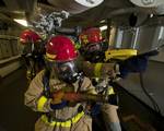 Hull Maintenance Technician Fireman Matthew Colon, left, and Damage Controlman Fireman Donovan Jopling, lead a hose team.