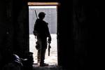 U.S. Army National Guard Sgt. Matthew Armstrong, a Security Force member of Provincial Reconstruction Team Farah, scans his sector while pulling security during a prison visit in Farah City, Farah province, Afghanistan, April 24. Armstrong is guarding coalition members who are visiting the prison to observe and provide recommendations to improve conditions.