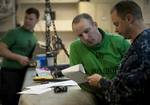 Aviation Electronics Technician 3rd Class Matthew Murphy, left, assigned to Aircraft Intermediate Maintenance Department's IM-3 Division