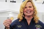 NEW YORK - Liberty Landing dockmaster Michelle Boggs holds a challenge coin presented to her by Coast Guard Captain Joseph Vojvodich, Commander of Coast Guard Sector Long Island Sound, Conn., Tuesday, Jan. 10, 2012. Boggs also received a certificate of appreciation for her dedicated support of Coast Guard Cutter Ridley by providing fuel and additional resources from her Jersey City, N.J., facility to the crew prior to Tropical Storm Irene impacting the port of New York and New Jersey in 2011. U.