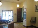 The interior, first-floor lobby of the courthouse building. The remaining original woodwork, sills, door frames, and interior doors, are all solid oak.