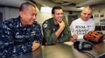 Lt. Cmdr. Tristan Oliveria, Lt. Michael Chalfant and Chief Yeoman Ken Ingle ask San Diego Padres catcher Nick Hundley questions during a holiday morale phone call.