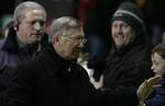 Manchester United's manager Sir Alex Ferguson, second from left, celebrates with fans after his side's 5-0 win over Burton Albion in their FA Cup 3rd round replay soccer match at Old Trafford Stadium, Manchester, England, Wednesday Jan. 18,