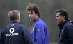 Manchester United's Ruud Van Nistelrooy, centre, speaks to manager Sir Alex Ferguson, left, and asistant manager Carlos Quieroz as the team trains in Manchester, England, Monday Oct. 17, 2005, before their Champion's League soccer match against Lille, to be played on Oct. 18 at Old Trafford.