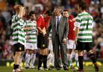 Former Manchester United captain Roy Keane, centre left, mops his forehead next to his former manager Sir Alex Ferguson, centre right, after Keane's testimonial soccer match against Celtic at Old Trafford Stadium, Manchester, England, Tuesday May 9, 2006.