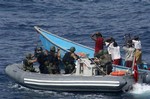 In this photo released by the Turkish military, Turkish commandos are seen with seven pirates in the Gulf of Aden, off the Somali coast, Friday, July 31, 2009.