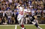 New York Giants quarterback Eli Manning (10) throws a pass in front of New England Patriots linebacker Rob Ninkovich (50) during the first half of the NFL Super Bowl XLVI football game Sunday, Feb. 5, 2012, in Indianapolis.