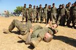 Cpl. Bradley Brouwer and Cpl. Lucas Ottander-Todd, assigned to the Marine detachment aboard High Speed Vessel (HSV 2) Swift, demonstrate an arm-bar to a group of Guatemalan paratroopers.