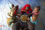 Somali refugee children share a meal inside a tent in Dollo Ado, Ethiopia. Fleeing drought and famine in their home country, thousands of Somalis have taken up residence across the border in Dollo Ado