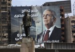 A statue of Egypt's Nobel laureate Naguib Mahfouz is back dropped with an electoral poster of presidential candidate Amr Moussa and Arabic writing which reads, "Egypt's reconstruction needs the effort of all Egyptians," in Cairo, Egypt, Tuesday, May 8, 2012.