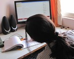 A teenager girl in front of computer using computer internet - India