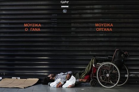 A homeless man sleeps on a sidewalk in Athens, Sunday, May 20 2012. Homelessness, the most visible sign of Greece's financial despair, has risen by around 25 percent.