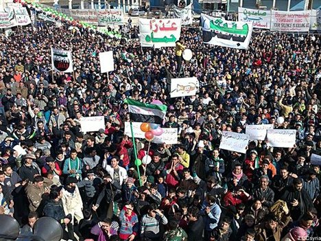 In this citizen journalism image provided by the Local Coordination Committees in Syria and released Friday, Feb. 3, 2012, anti-Syrian regime protesters march in Bensh, Idlib Province, northern Syria.